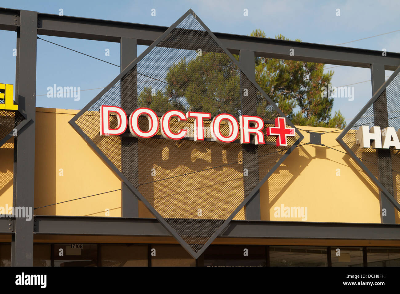 A doctors office sign with red cross in Santa Ana Southern California USA Stock Photo