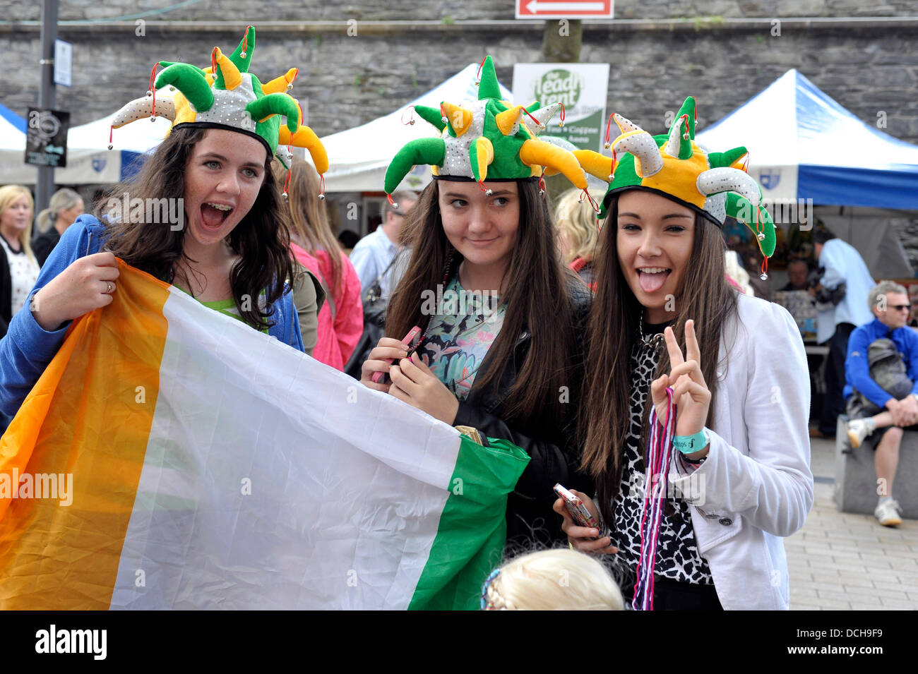 Derry, Londonderry, UK. 18th August 2013. Young girls, in Guildhall Square, enjoying the final day of the week long Fleadh Cheoil, the biggest celebration of Irish traditional and folk music in the world. Over 300,000 visitors experienced the week long Irish culture festival. .  Credit: George Sweeney / Alamy Live News Stock Photo