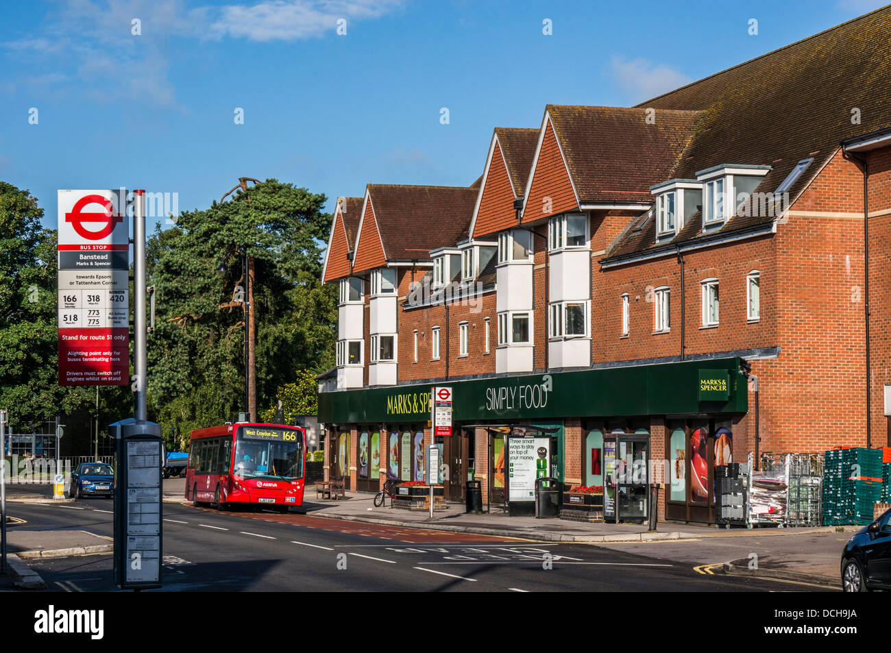 Marks and & Spencer (M&S) store / shop, with local bus outside, on