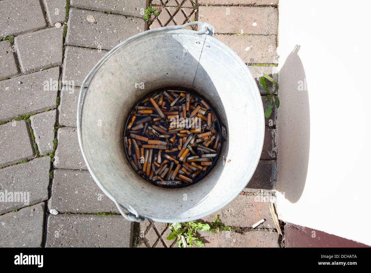 Bucket of cigarette butts outside a country public house, West Country, UK Stock Photo Alamy