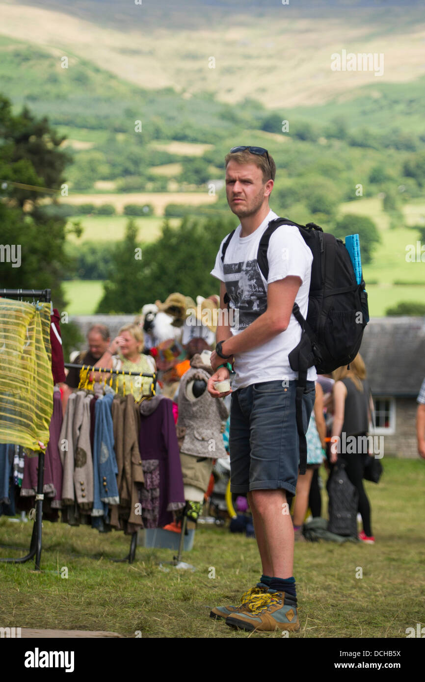 Crickhowell, Wales, UK. 18th August 2013. Day four of Green Man Festival. A man queues up at a food stall, with the mountains of the Brecon Beacons in the background. Credit:  Polly Thomas/Alamy Live News Stock Photo