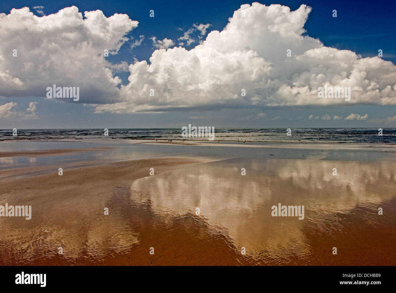 Abstract images of clouds reflected in wet sand. Stock Photo