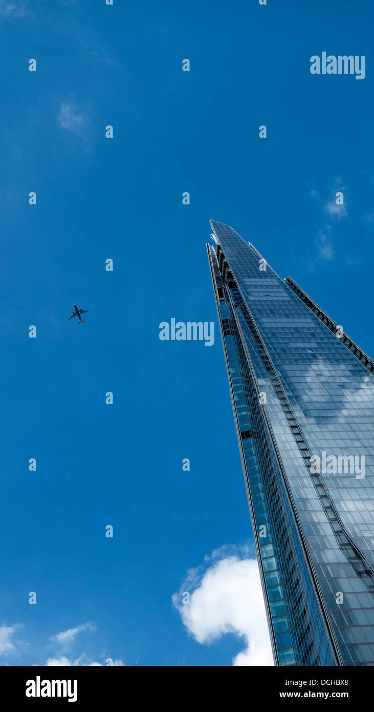Low angle view of the Shard skyscraper building and plane in  blue sky London England UK  KATHY DEWITT Stock Photo