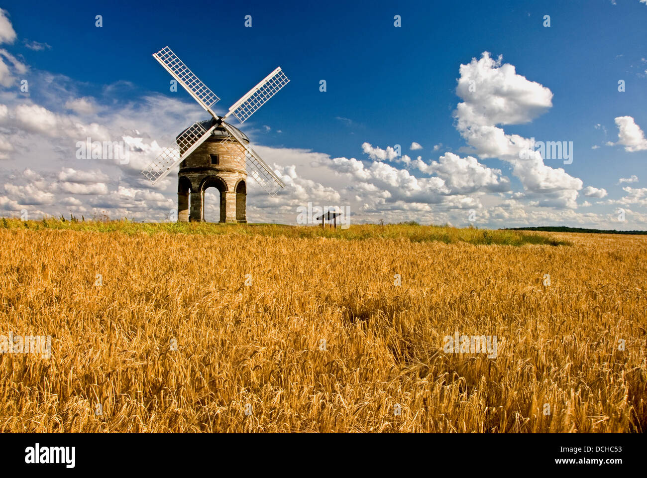Chesterton Windmill is a landmark building in South Warwickshire seen with ripening wheat and cumulus clouds in a blue sky Stock Photo