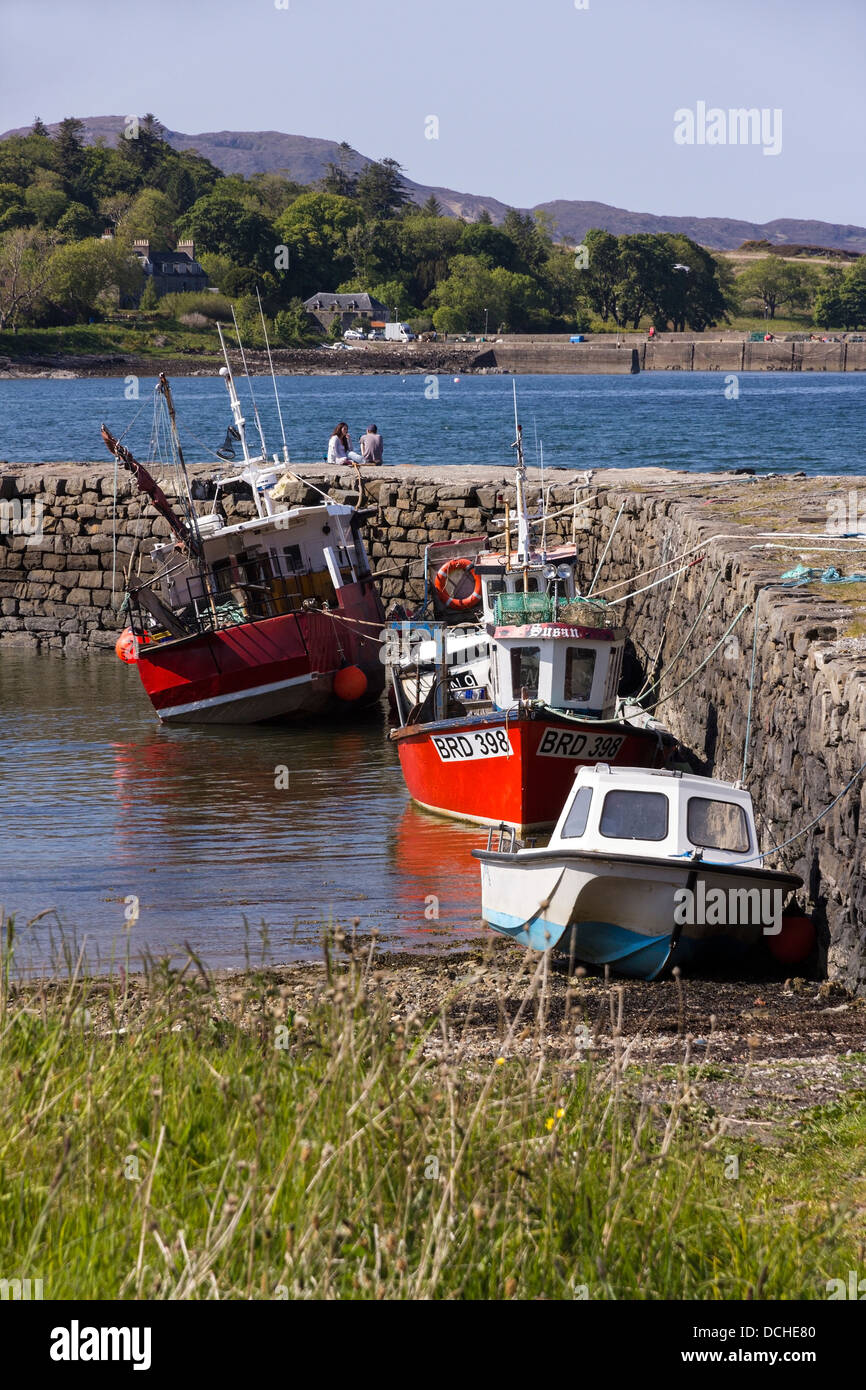 Small red and white fishing boats moored at Broadford Pier, Broadford, Isle of Skye, Scotland, UK Stock Photo