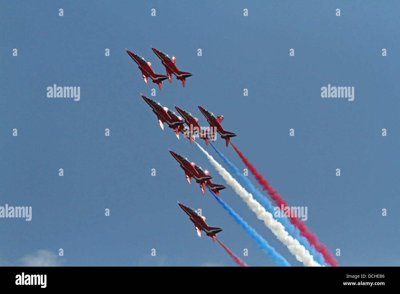 Eastbourne,UK,18th August 2013,The Red Arrows fly with red white and blue smoke in the sunshine during the Airbourne air display in Eastbourn Credit: Keith Larby/Alamy live News Stock Photo