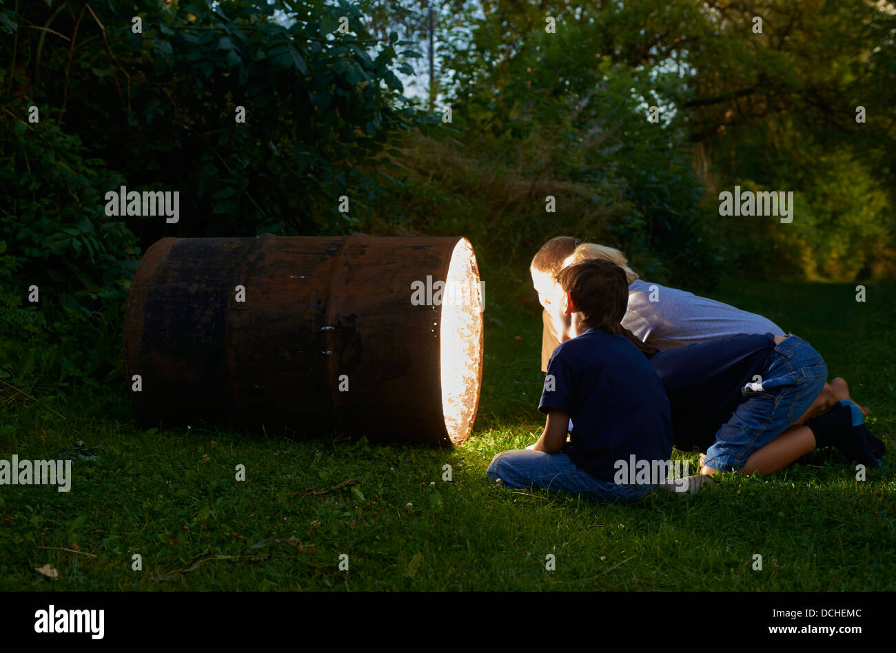 Child boy find a treasure in magic barrel at dusk Stock Photo