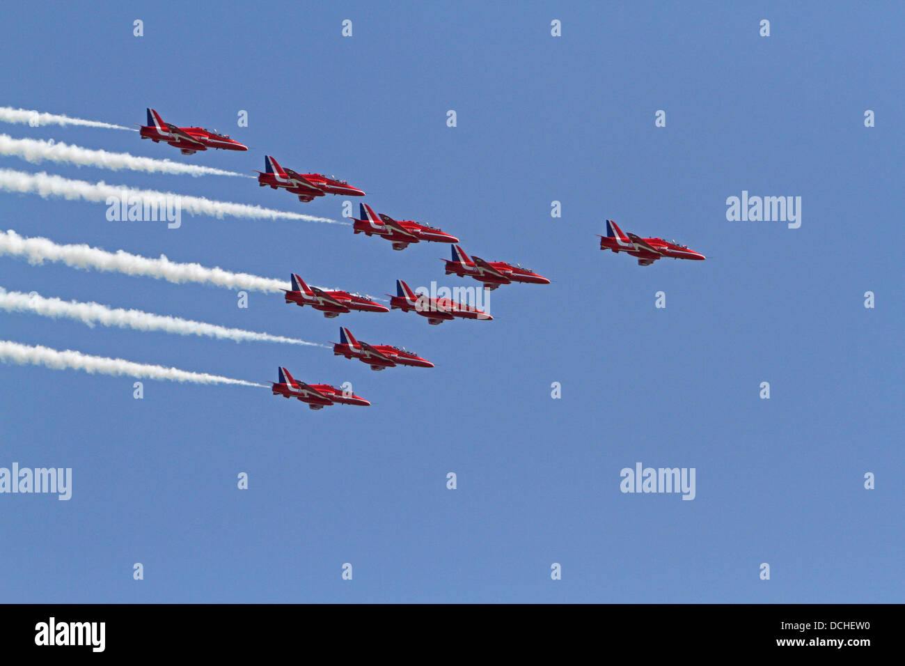 Eastbourne,UK,18th August 2013,The Red Arrows fly with smoke on over the pier in the sunshine during the Airbourne air display in Eastbourn Credit: Keith Larby/Alamy live News Stock Photo