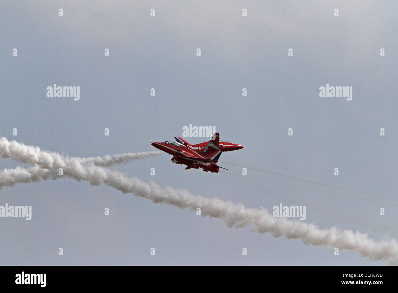 Eastbourne,UK,18th August 2013,The Red Arrows criss cross at 400mph in the sunshine during the Airbourne air display in Eastbourn Credit: Keith Larby/Alamy live News Stock Photo