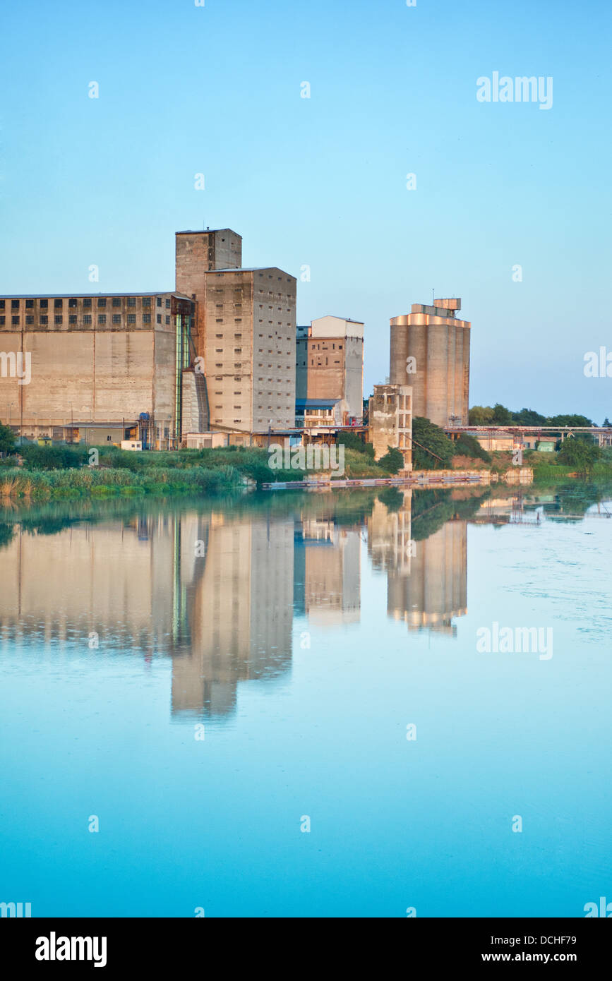 Old granaries for storing wheat and other cereal grains near the river Stock Photo
