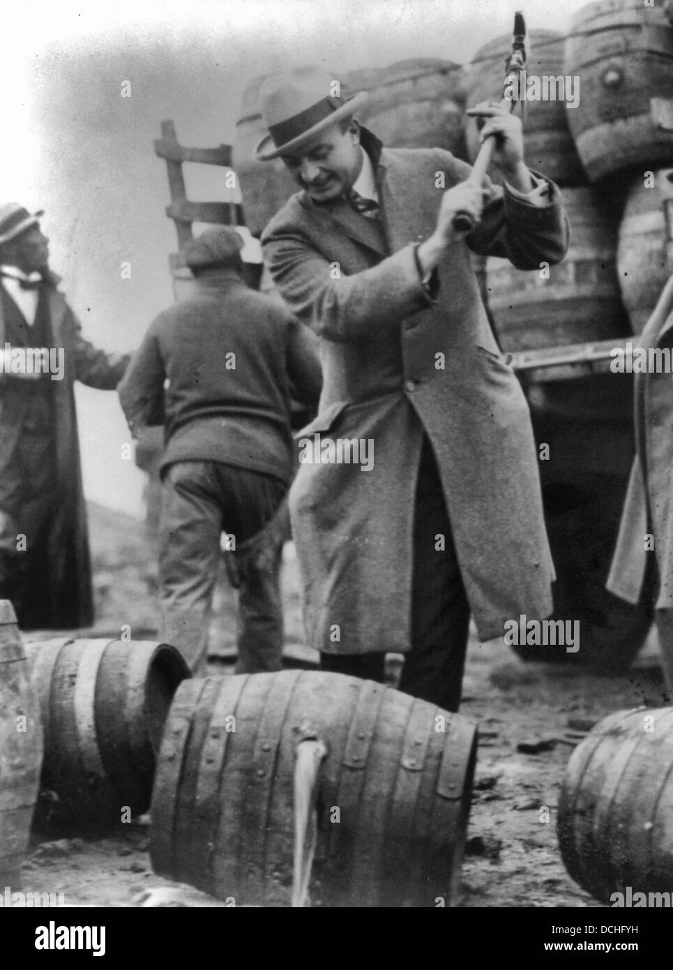 Putting a kick in the staid old Schuylkill here go a few barrels of beer -- not 1/2 of 1 percent -- into the Schuylkill River.  Public Safety Director, Smedley D. 'Duckboards' Butler, destroying kegs of beer with an axe, 1924. Stock Photo