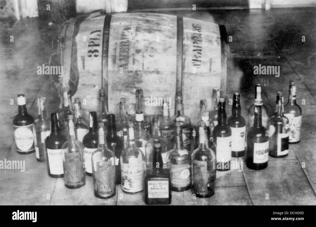 Bottles and barrel of confiscated whiskey, USA prohibition, circa 1925 Stock Photo