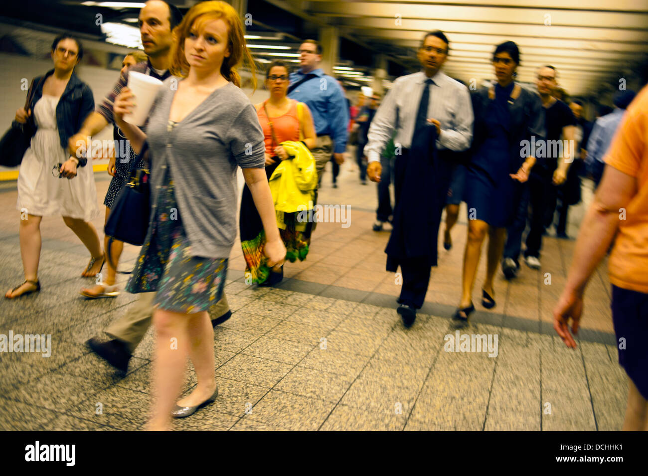 Crowd of people walking in a  New York City subway tunnel Stock Photo