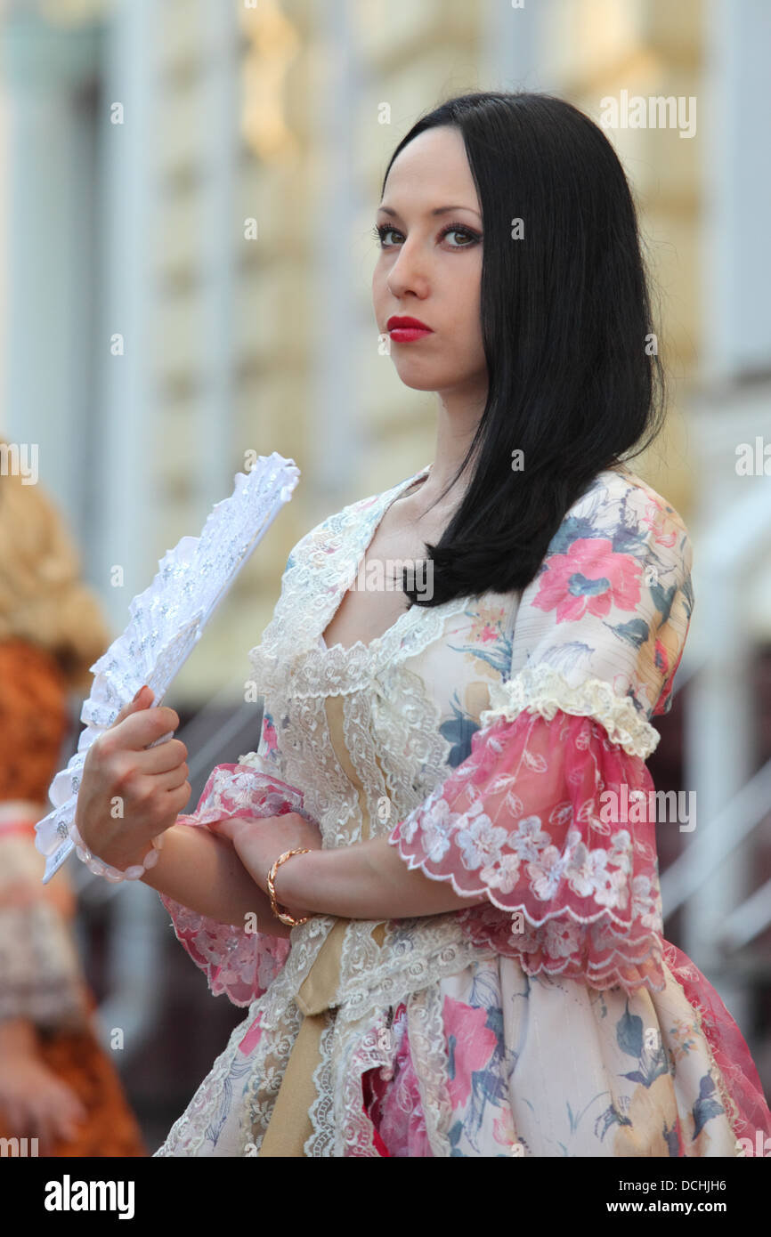 Girl in a ball dress in the Russian romantic style and a fan in her ...