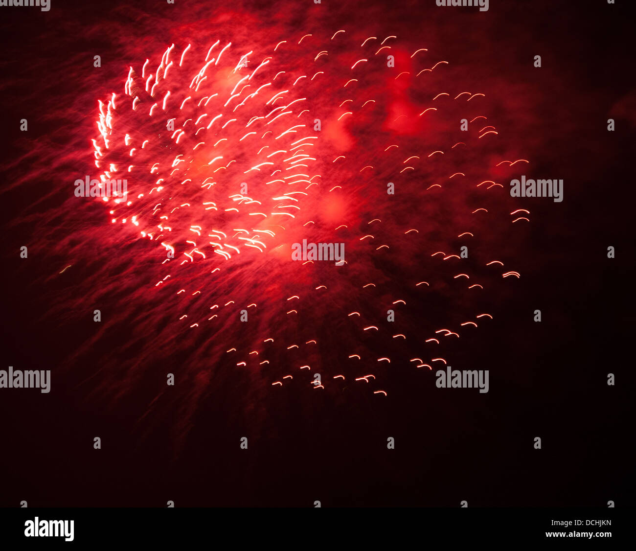 Red fireworks in the dark night sky Stock Photo