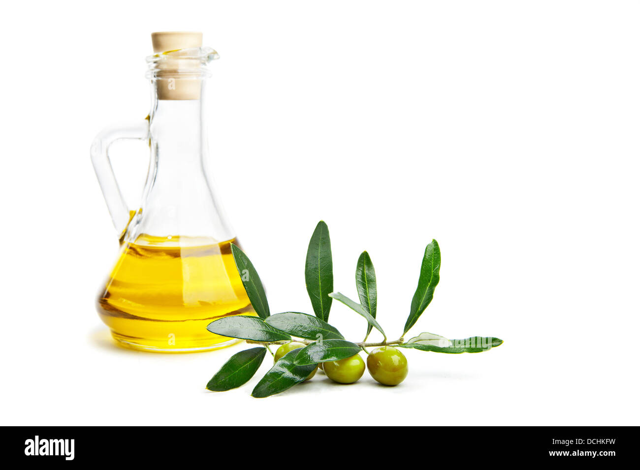 Glass bottle of virgin olive oil and branch with olives isolated on ...