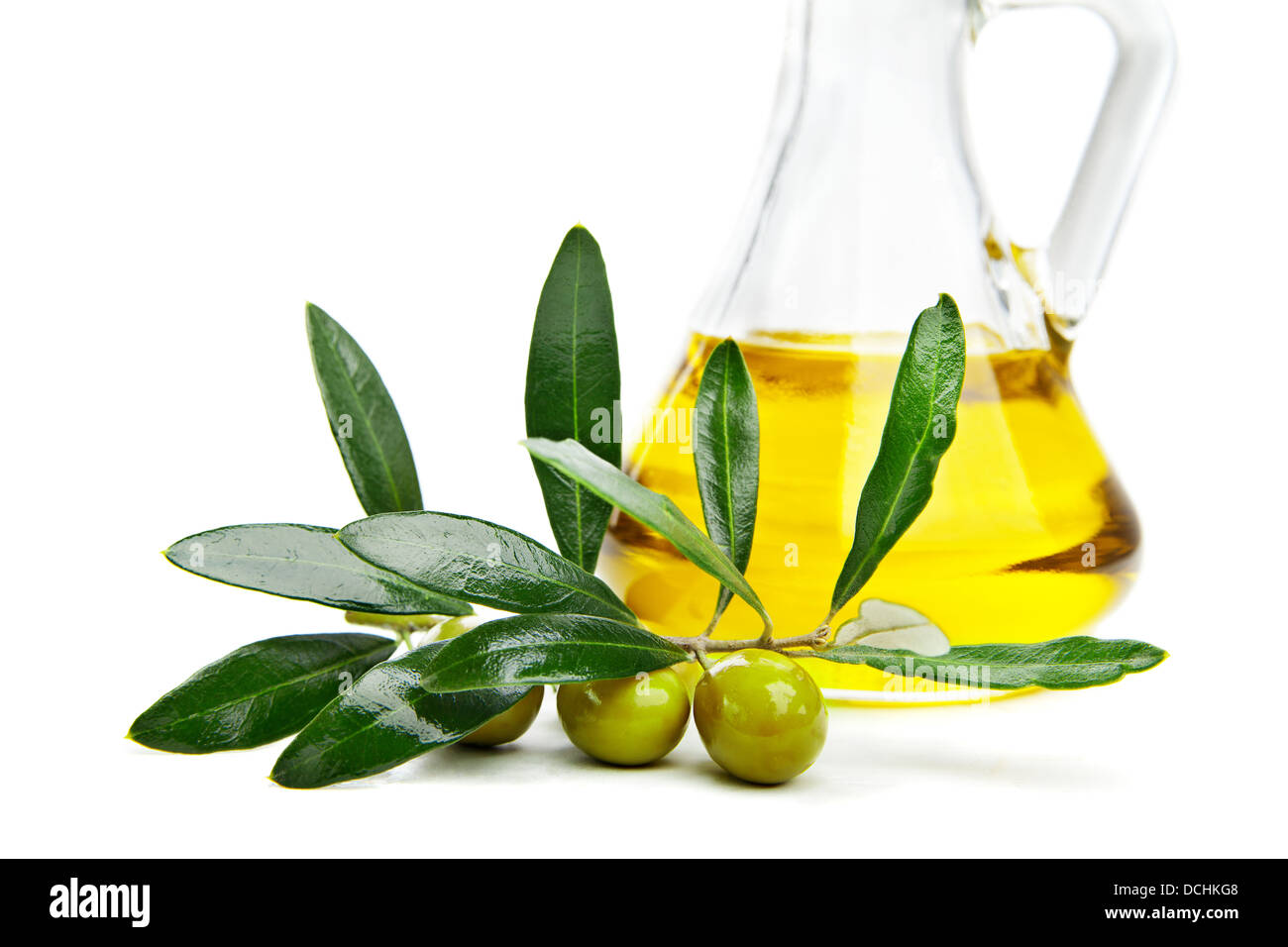 Glass bottle of virgin olive oil and branch with olives isolated on ...