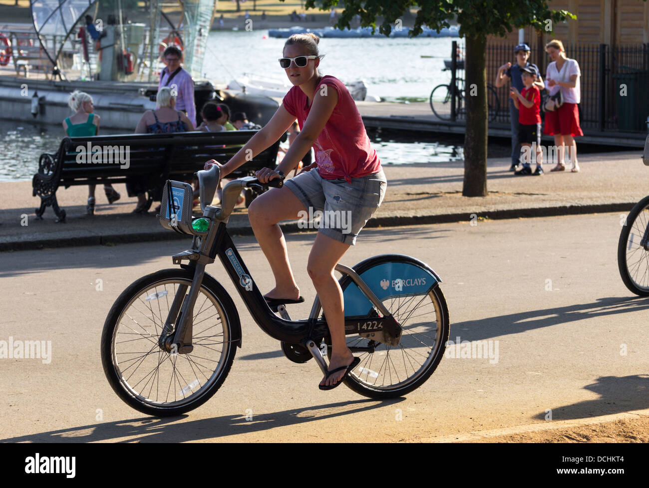 Women riding hired Cycle - Hyde Park - London [Barclays bike hire scheme] Stock Photo