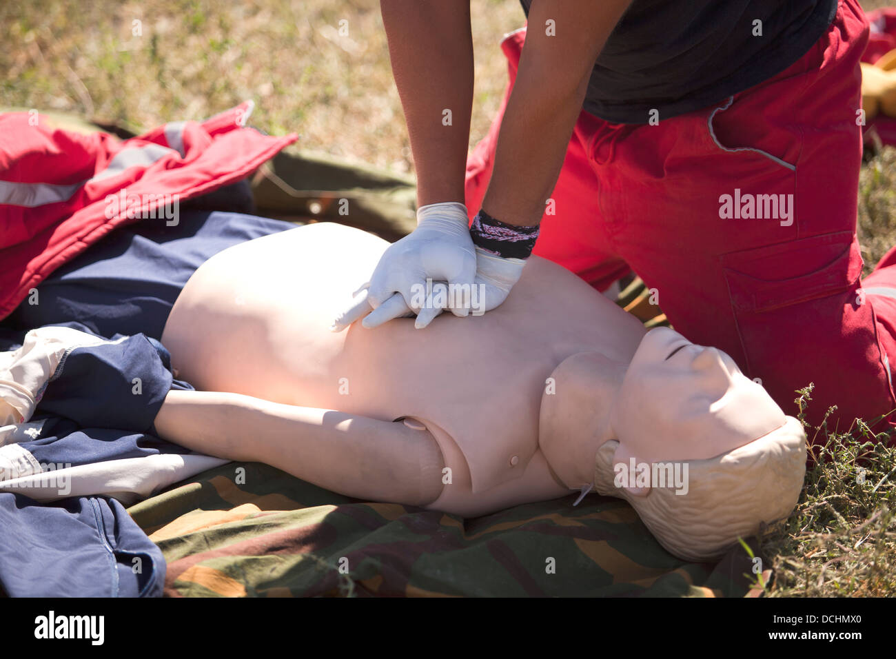 paramedic demonstrates CPR on dummy Stock Photo