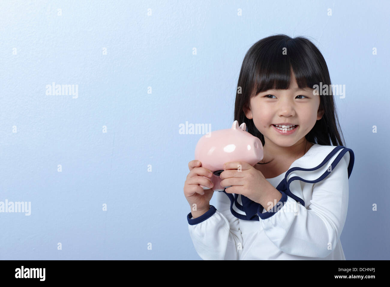 a girl with a piggy bank Stock Photo - Alamy