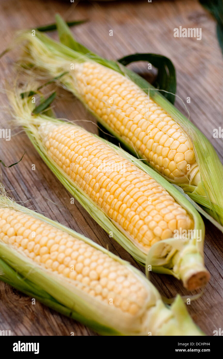 Fresh corn on wooden surface Stock Photo