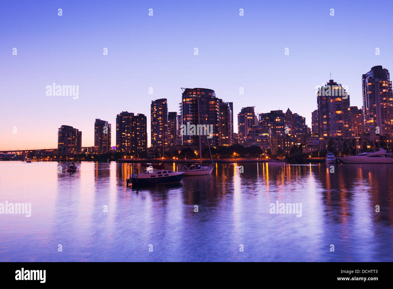 Modern Urban City Skyline Reflecting in Water at Sunset, Vancouver Stock Photo