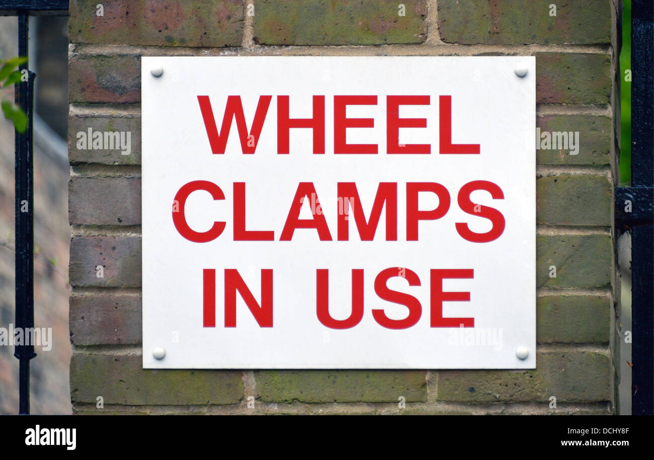 'WHEEL CLAMPS IN USE' sign. Trumpington Street, Cambridge, Cambridgeshire, England, United