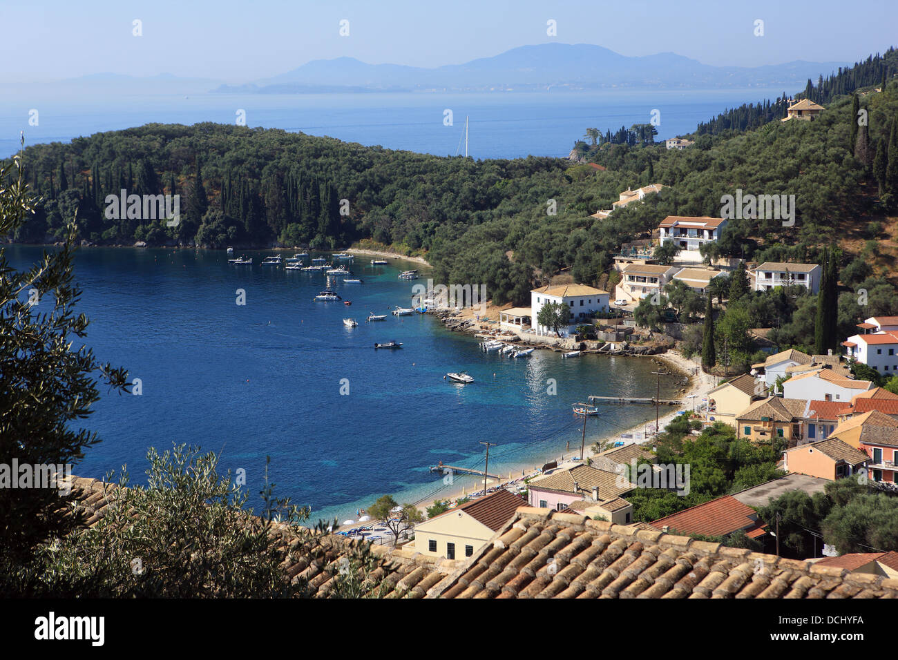 View over Kalami Bay, with The White House, home to Lawrence and Gerald Durrell to the right of centre jutting out into the sea Stock Photo
