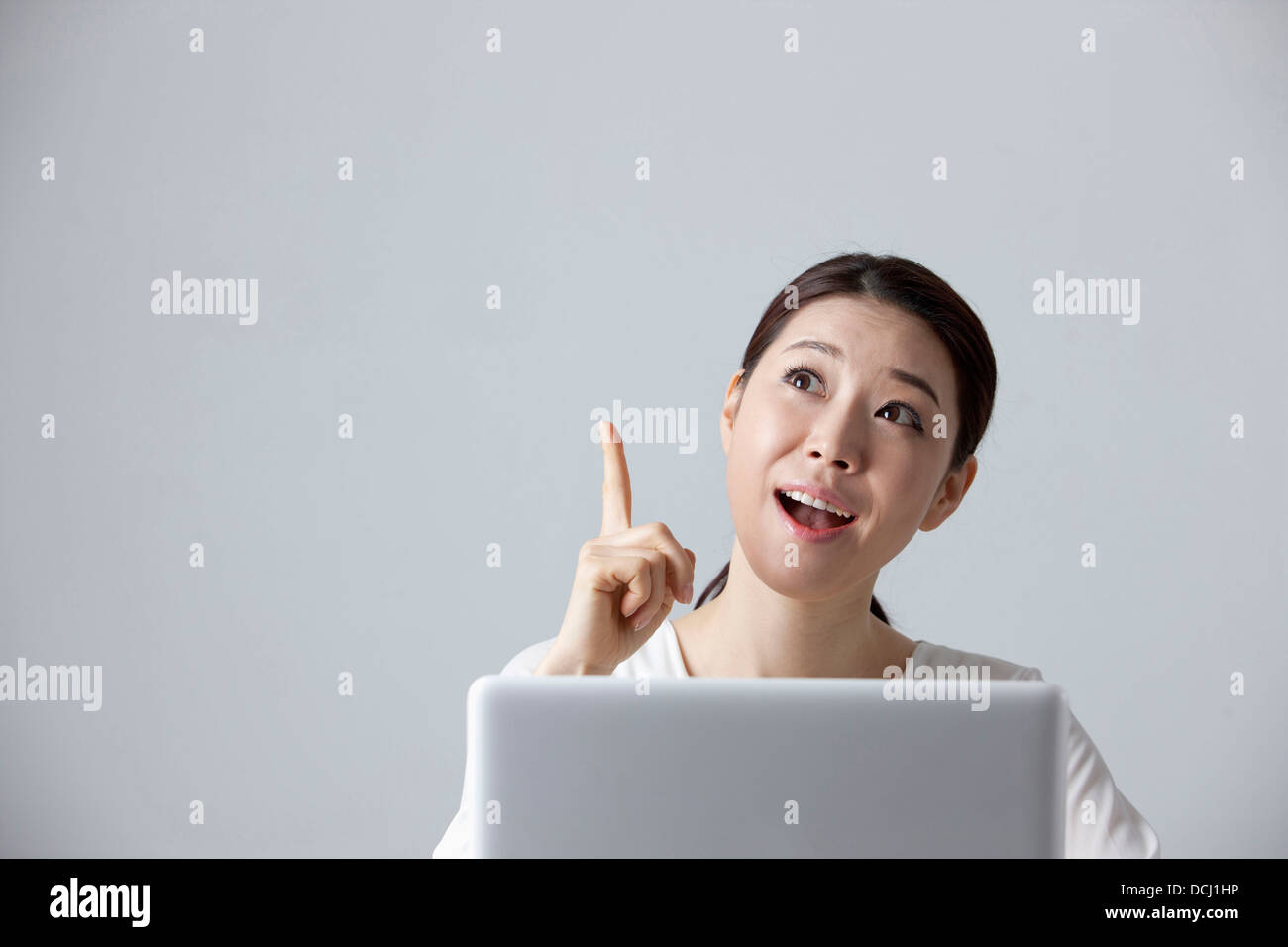 a woman thinking while using a laptop Stock Photo - Alamy