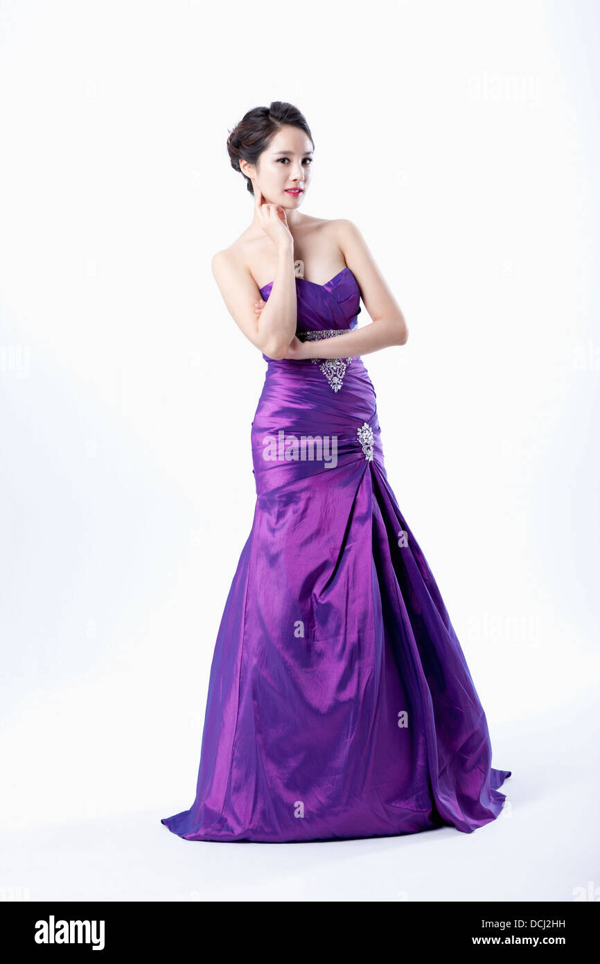 a lady in fancy purple dress posing Stock Photo - Alamy