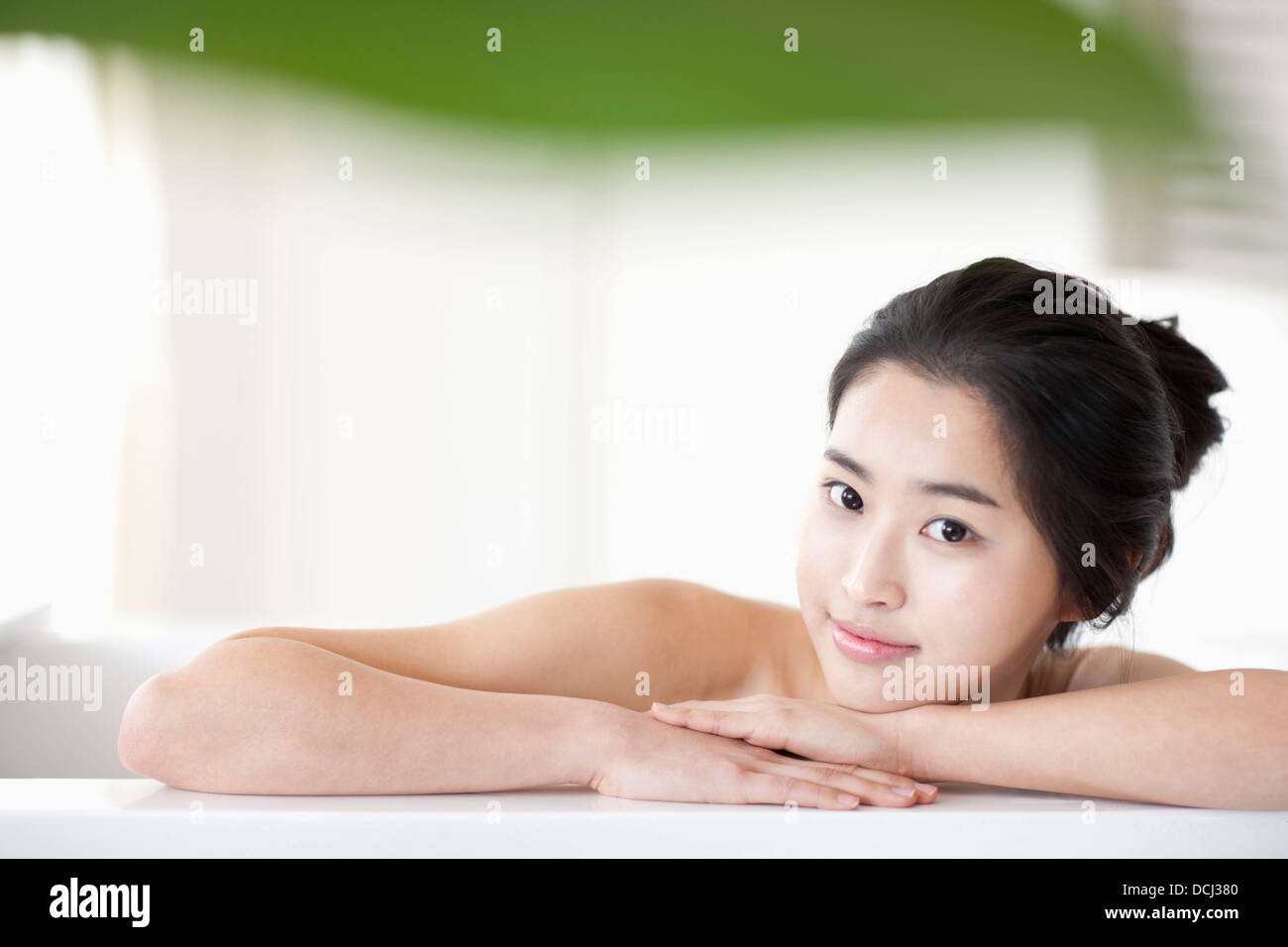 a woman in leaning on a Jacuzzi Stock Photo