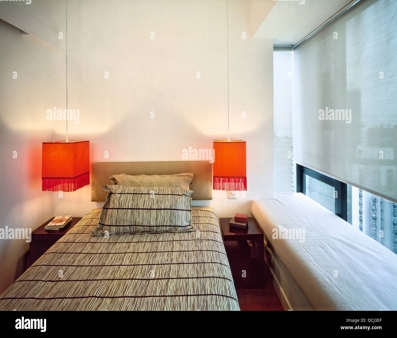 Bedroom With Orange Hanging Bedside Lights In A Modern