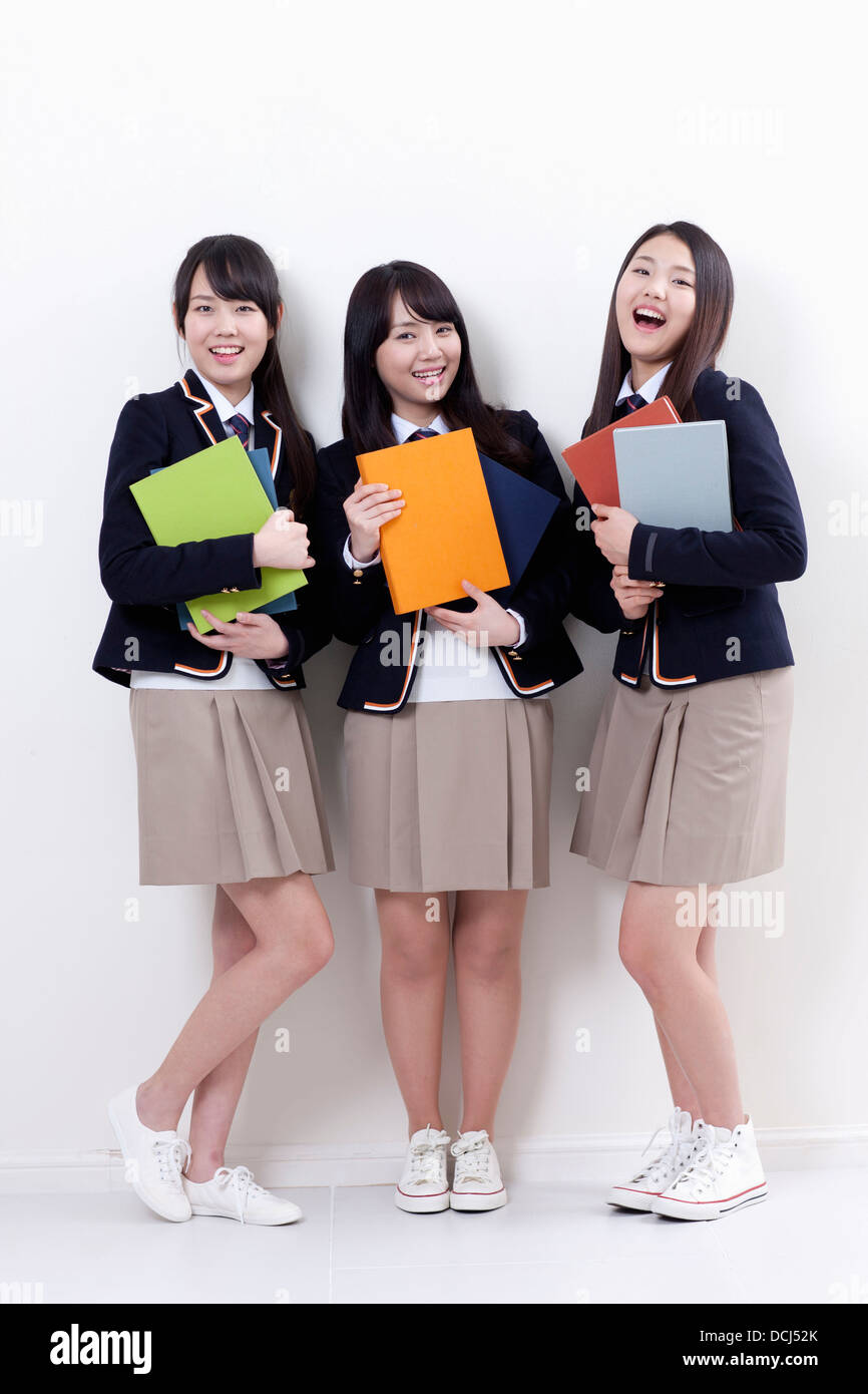 students in uniform holding books Stock Photo - Alamy