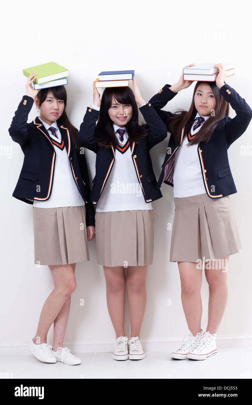students in uniform holding books Stock Photo - Alamy