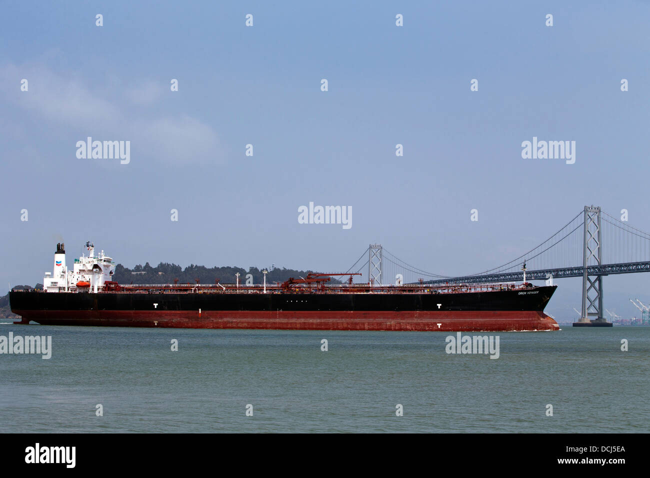 The Orion Voyager, a Chevron Oil Tanker passes under the Bay Bridge, San Francisco, California, United States of America Stock Photo