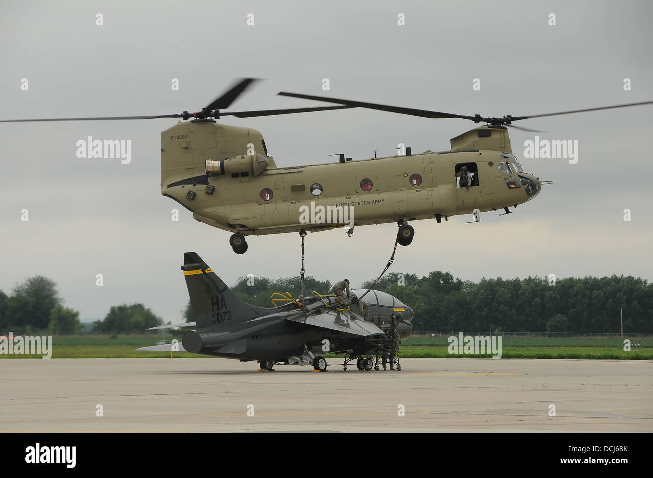 A CH-47F Chinook Helicopter from the Iowa Army National Guard’s B-2-211 General Support Aviation Battalion (GSAB) from Davenport, Iowa lifts an A-7D Corsair at the 185th Air Refueling Wing in Sioux City, Iowa. The vintage Corsair is being brought to Camp Stock Photo