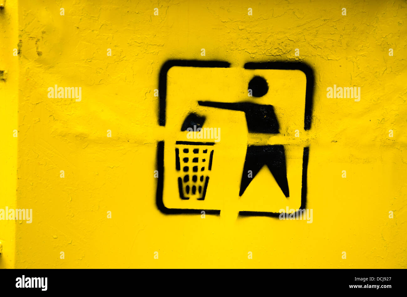 vintage black recycling symbol on yellow  trashcan Stock Photo