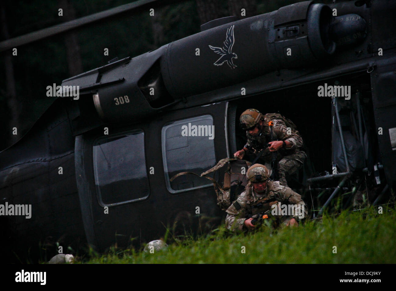 U.S. Air Force Airman 1st Class Josh Darins and Staff Sgt. Kane Lawlor exit a U.S. Army UH-60 Black Hawk Helicopter from the New Jersey Army National Guard's 1-150 Assault Helicopter Battalion during an air insertion exercise at Fort Pickett, Va., on Aug Stock Photo