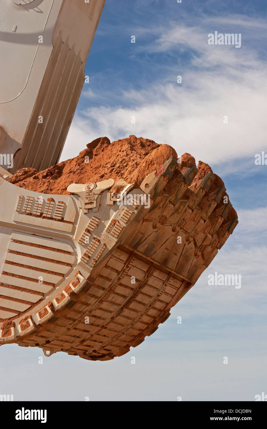 Open pit gold mining in Mauritania. Close up of giant excavator bucket carrying ore. West Africa