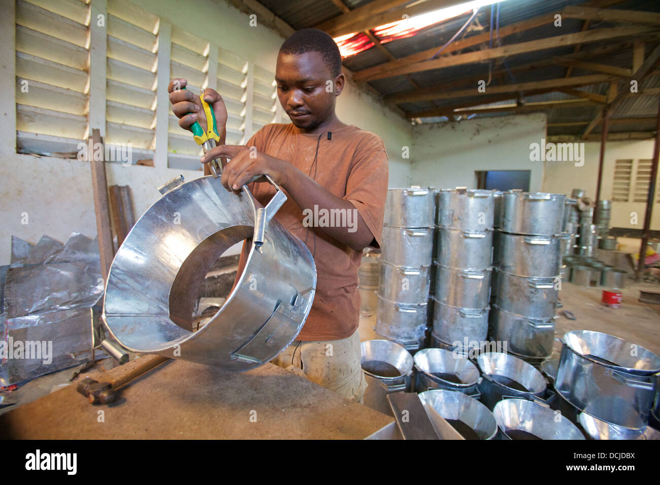 Metal craftsman constructing an african cooking stove, Tanzania Stock