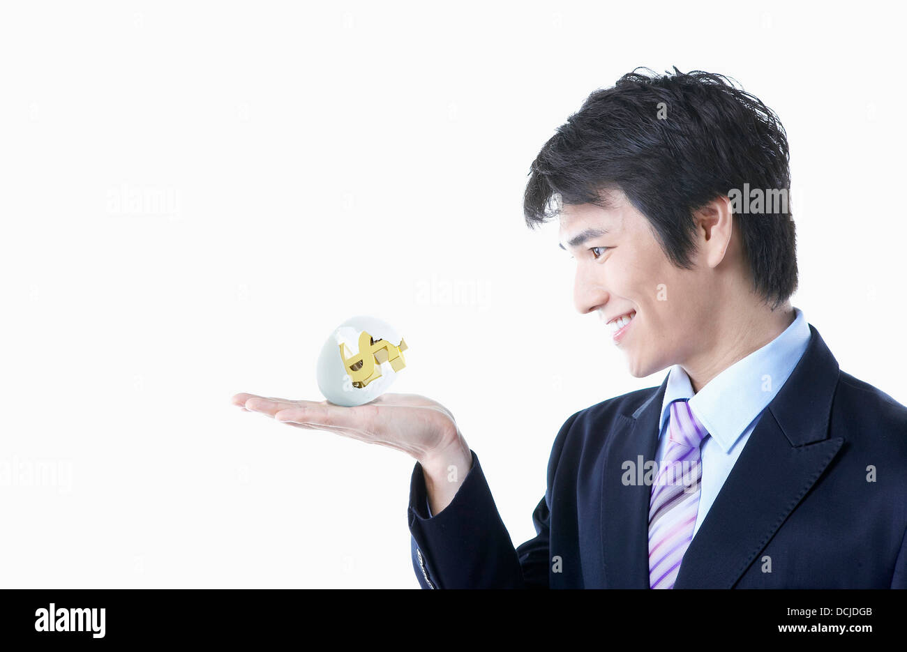 a businessman holding dollar sign Stock Photo - Alamy