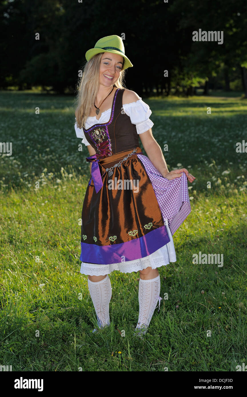 Young Woman Wearing Traditional Bavarian Dress Dirndl And Green Hat In