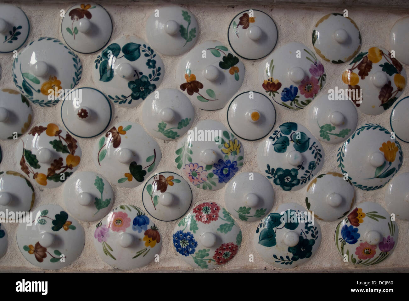 Unusual Italian kitchen wall design consisting of teapot lids, of an apartment in Sorrento, Campania, Italy Stock Photo
