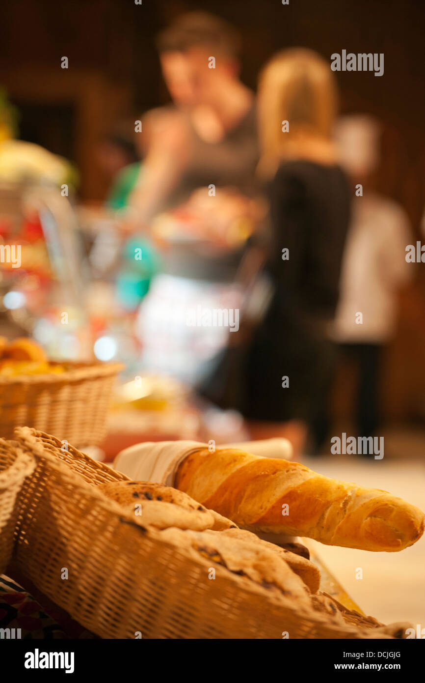 shallow focus image of a buffet with bread in foreground.Abstract image. Stock Photo