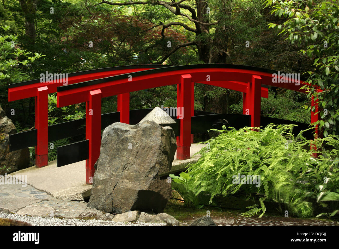 A red bridge in a Japanese style garden. Stock Photo