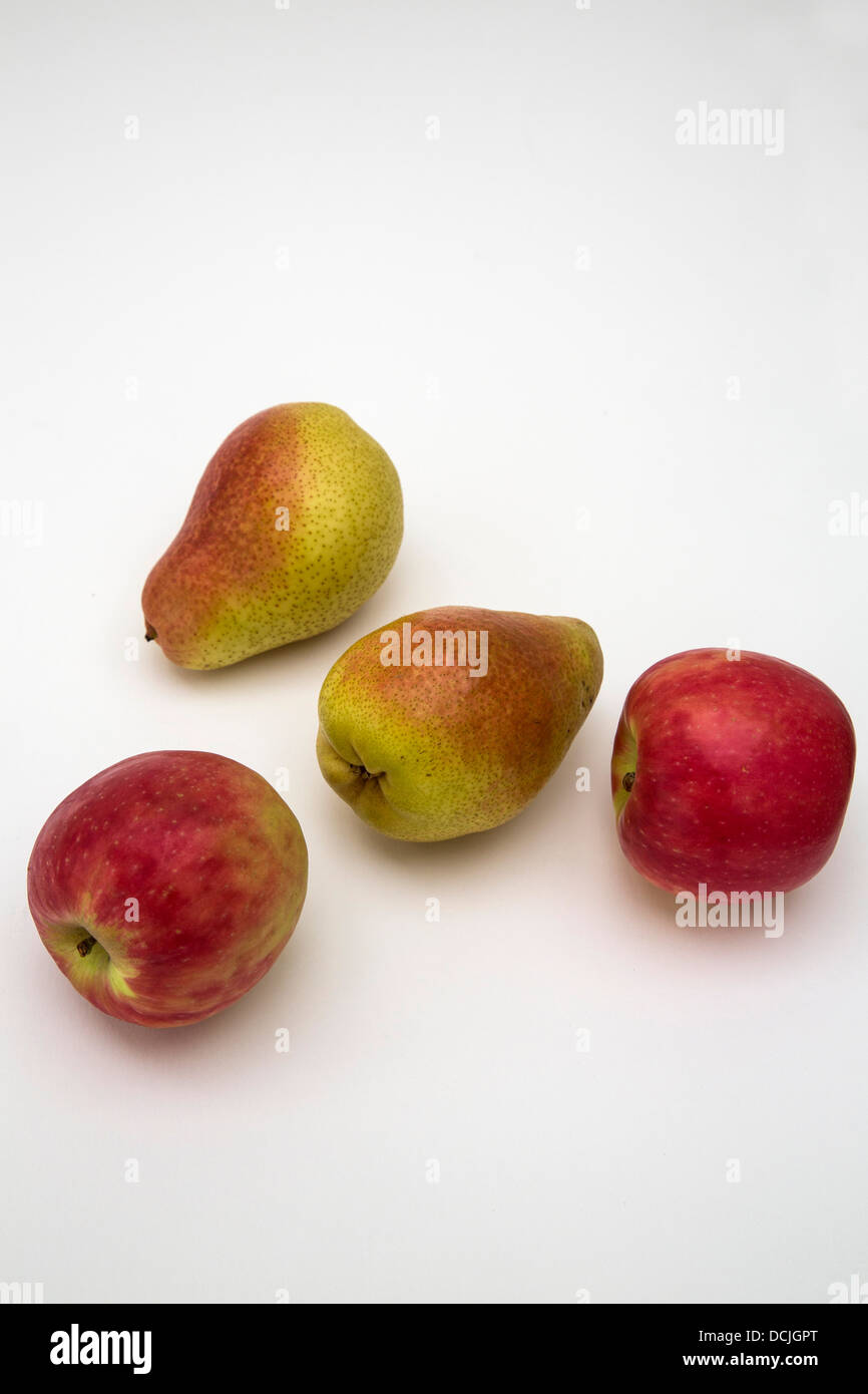 Two rosy apples and two rosy pears against a white background. Stock Photo