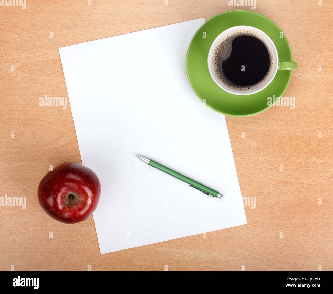 Blank paper with pen, coffee cup and red apple on wood table Stock Photo