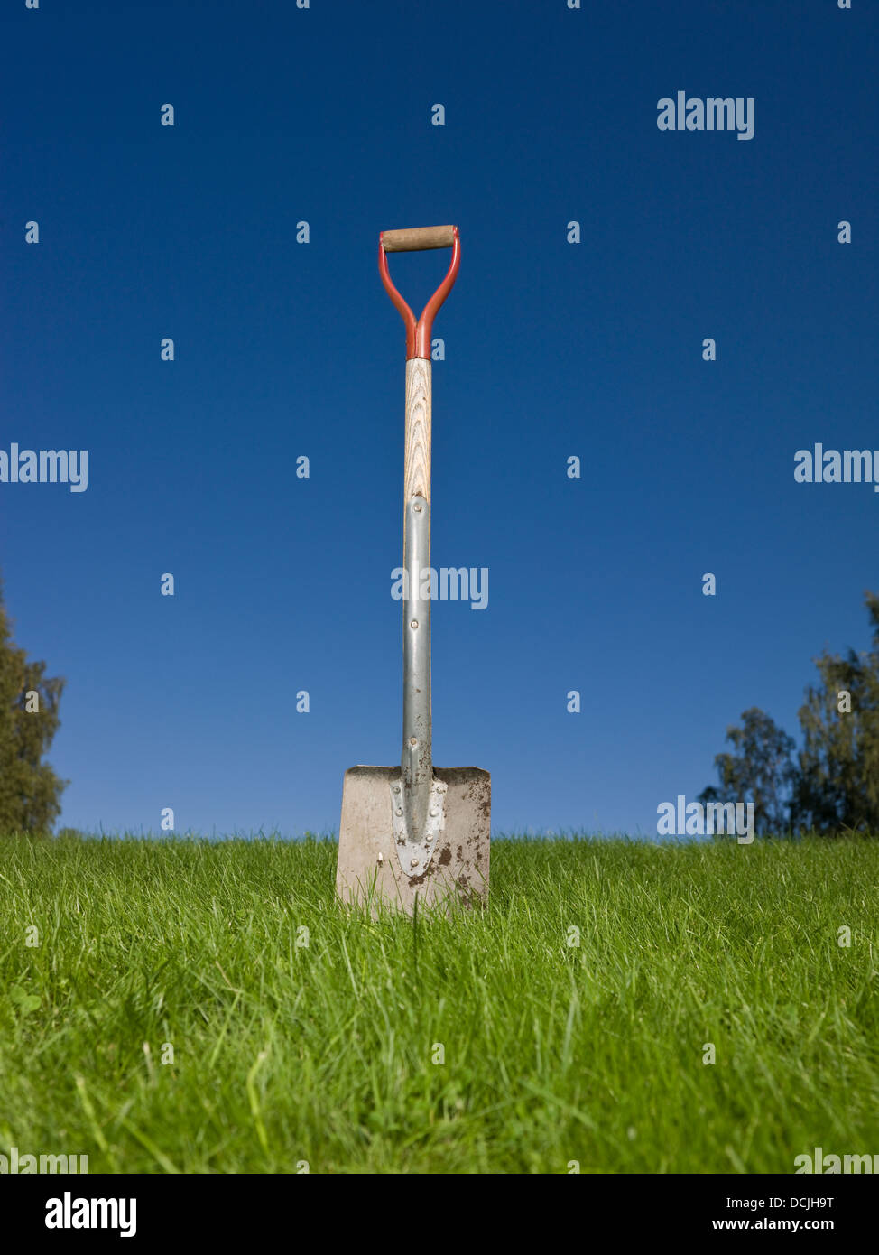 Shovel stuck in the ground Stock Photo - Alamy