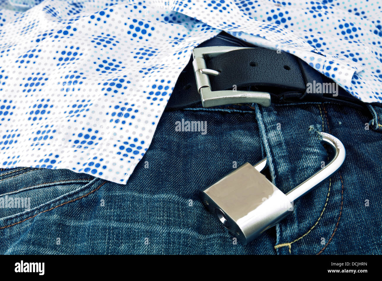 Steel Padlock locked submitting jeans under Men's shirt Stock Photo Alamy