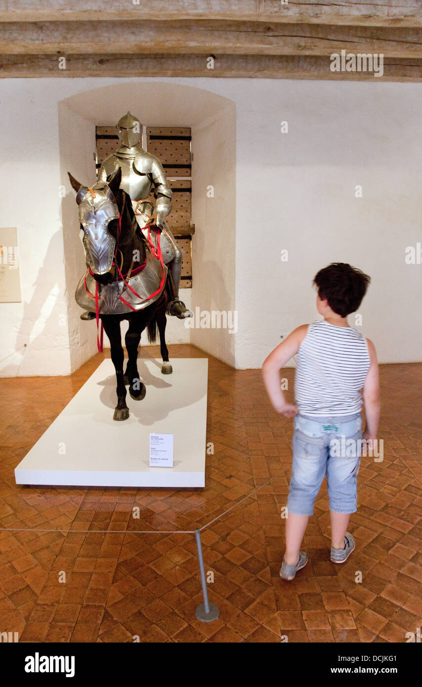 A child in the Museum of medieval Warfare, Chateau ( castle ) of Castelnaud-la-Chapelle, the Dordogne, France, Europe Stock Photo